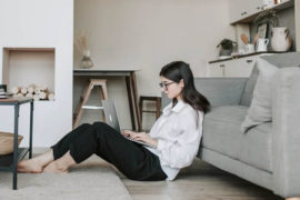 Woman Sitting On The Floor Using A Laptop