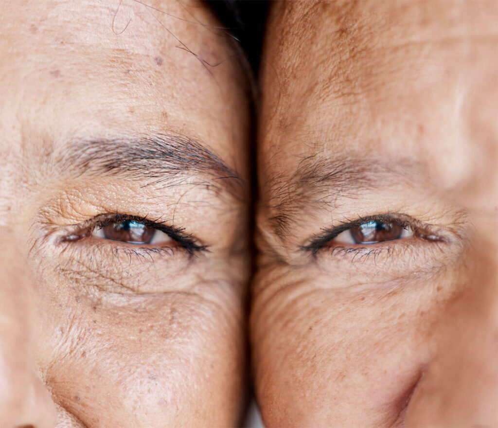 Senior twins closeup, faces touching.