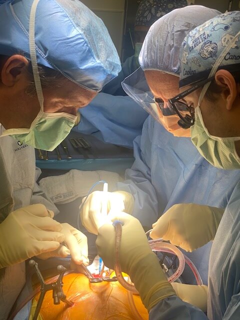 Dr Earl Brien and Dr. J. Patrick Johnson perform computer-guided coccygeal lesion resection.